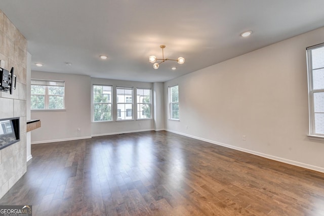 3360 Pickens St, Duluth, GA 30096 - unfurnished living room featuring a fireplace, plenty of natural light, dark wood-style flooring, a chandelier, and recessed lighting