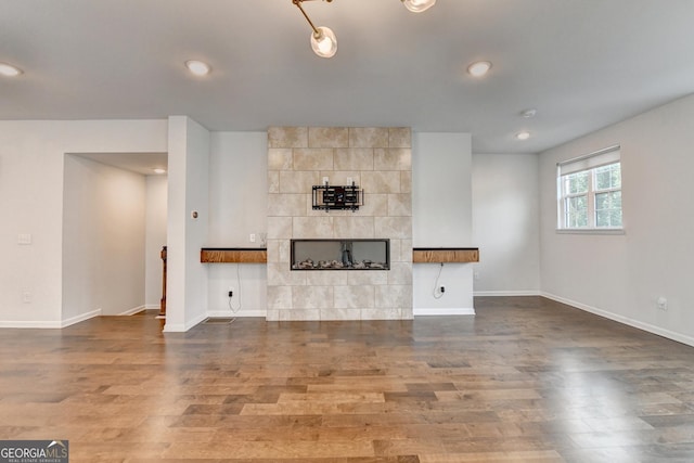 3360 Pickens St, Duluth, GA 30096 - unfurnished living room featuring wood finished floors, a fireplace, baseboards, and recessed lighting