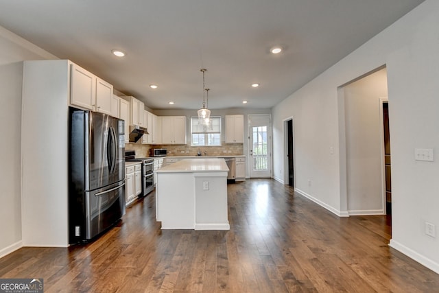 3360 Pickens St, Duluth, GA 30096 - kitchen featuring stainless steel appliances, light countertops, baseboards, dark wood-style flooring, and white cabinetry