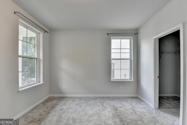 3360 Pickens St, Duluth, GA 30096 - unfurnished bedroom with carpet floors, multiple windows, a walk in closet, and baseboards