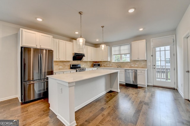 3360 Pickens St, Duluth, GA 30096 - kitchen featuring stainless steel appliances, a kitchen island, white cabinets, light countertops, and recessed lighting