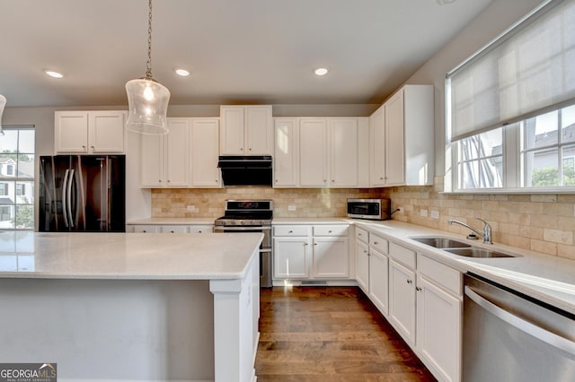 3360 Pickens St, Duluth, GA 30096 - kitchen with appliances with stainless steel finishes, a sink, extractor fan, white cabinetry, and healthy amount of natural light