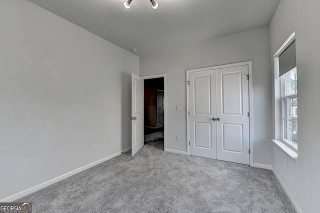 3360 Pickens St, Duluth, GA 30096 - unfurnished bedroom featuring carpet flooring, multiple windows, and a closet