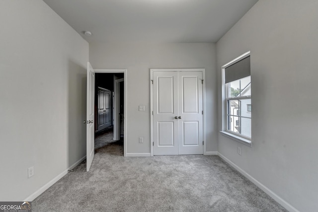 3360 Pickens St, Duluth, GA 30096 - unfurnished bedroom featuring carpet floors, baseboards, and a closet