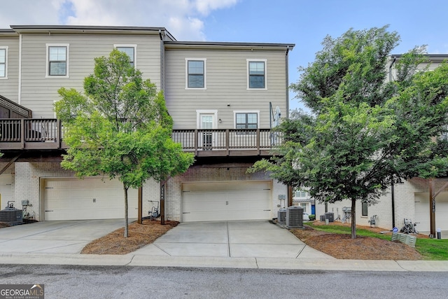 3360 Pickens St, Duluth, GA 30096 - view of front of property with an attached garage, concrete driveway, cooling unit, and brick siding