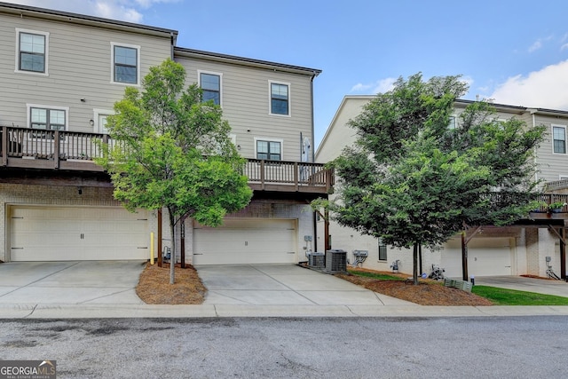 3360 Pickens St, Duluth, GA 30096 - view of front facade featuring a garage, driveway, and central AC