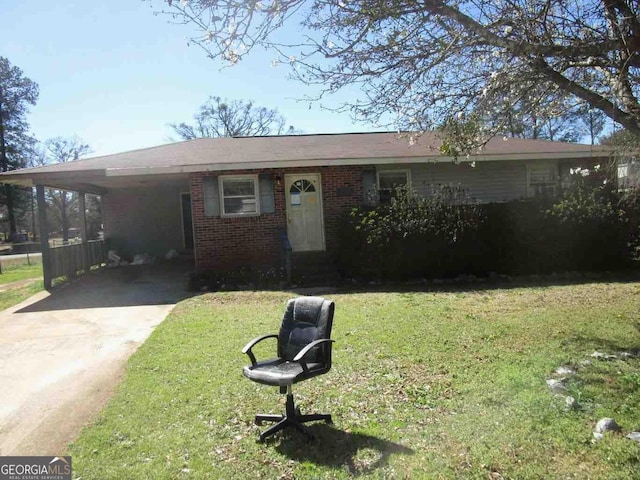 513 E Poplar St, Thomaston, GA 30286 - view of front of house featuring a carport, brick siding, a front lawn, and driveway