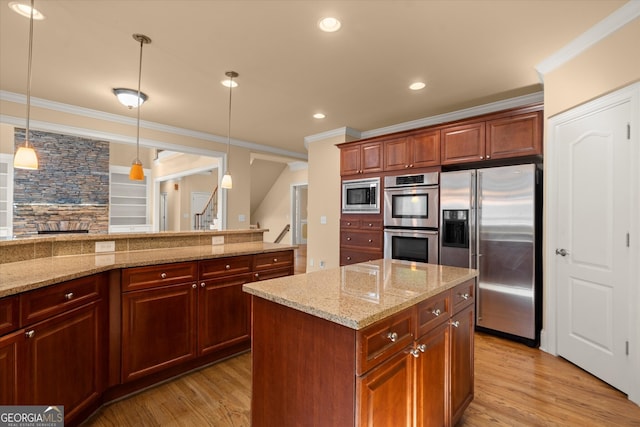 10565 Highgate Manor Ct, Duluth, GA 30097 - kitchen featuring stainless steel appliances, ornamental molding, light wood-style floors, decorative light fixtures, and light stone countertops