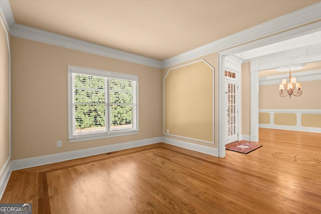 10565 Highgate Manor Ct, Duluth, GA 30097 - spare room featuring a chandelier, wood finished floors, crown molding, and baseboards