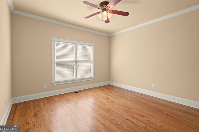 10565 Highgate Manor Ct, Duluth, GA 30097 - spare room featuring a ceiling fan, baseboards, light wood-style floors, and crown molding
