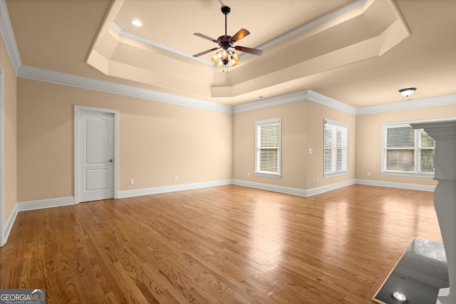 10565 Highgate Manor Ct, Duluth, GA 30097 - unfurnished living room with a raised ceiling, a ceiling fan, wood finished floors, ornamental molding, and baseboards