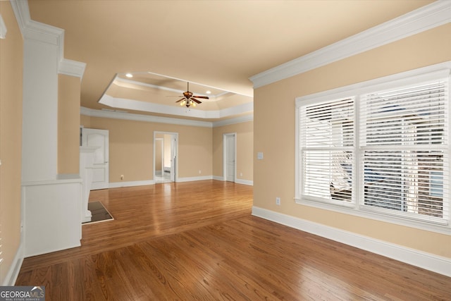 10565 Highgate Manor Ct, Duluth, GA 30097 - unfurnished living room featuring ornamental molding, a raised ceiling, wood finished floors, recessed lighting, and a ceiling fan