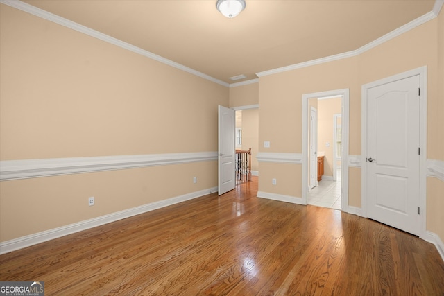 10565 Highgate Manor Ct, Duluth, GA 30097 - unfurnished bedroom featuring ornamental molding, wood finished floors, baseboards, and connected bathroom