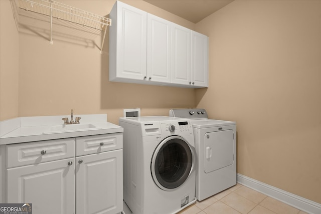10565 Highgate Manor Ct, Duluth, GA 30097 - laundry room with cabinet space, washer and dryer, baseboards, and light tile patterned flooring