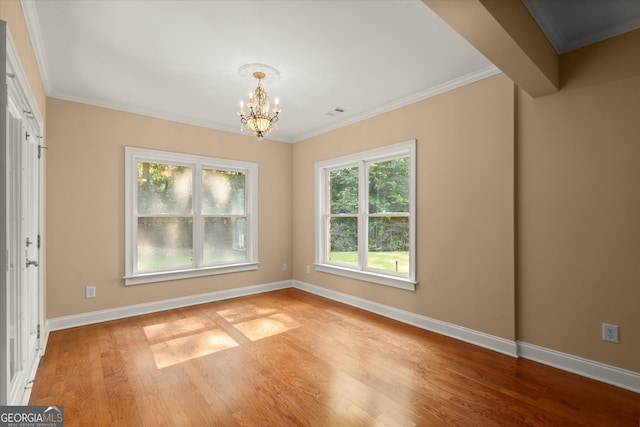 10565 Highgate Manor Ct, Duluth, GA 30097 - spare room with a chandelier, baseboards, light wood-style flooring, and crown molding