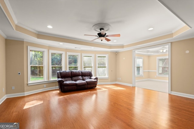 10565 Highgate Manor Ct, Duluth, GA 30097 - living area featuring a tray ceiling, ceiling fan, ornamental molding, plenty of natural light, and wood finished floors