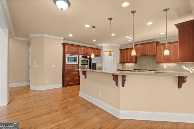10565 Highgate Manor Ct, Duluth, GA 30097 - kitchen featuring appliances with stainless steel finishes, a kitchen bar, ornamental molding, brown cabinets, and tasteful backsplash