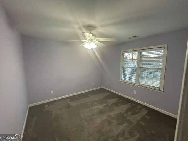 3808 Holy Cross Ct, Decatur, GA 30034 - empty room featuring a ceiling fan, dark colored carpet, and baseboards