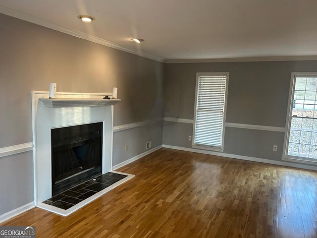 3808 Holy Cross Ct, Decatur, GA 30034 - unfurnished living room featuring wood finished floors, a tiled fireplace, baseboards, and ornamental molding