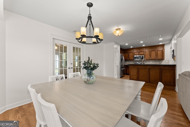 2605 Fort Apachee Trl, Dacula, GA 30019 - dining area with a chandelier, french doors, wood finished floors, recessed lighting, and baseboards
