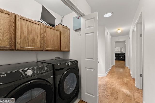 2605 Fort Apachee Trl, Dacula, GA 30019 - washroom featuring cabinet space, washing machine and clothes dryer, light wood-type flooring, and baseboards