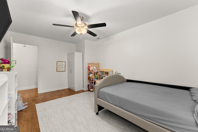 2605 Fort Apachee Trl, Dacula, GA 30019 - bedroom with wood finished floors, ceiling fan, and baseboards