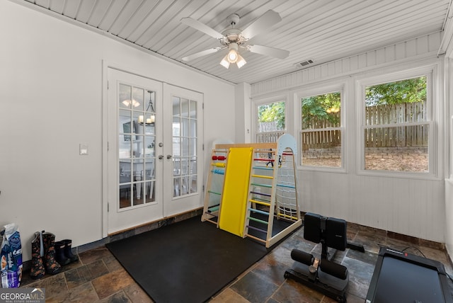 2605 Fort Apachee Trl, Dacula, GA 30019 - exercise room with french doors, stone tile flooring, and a ceiling fan