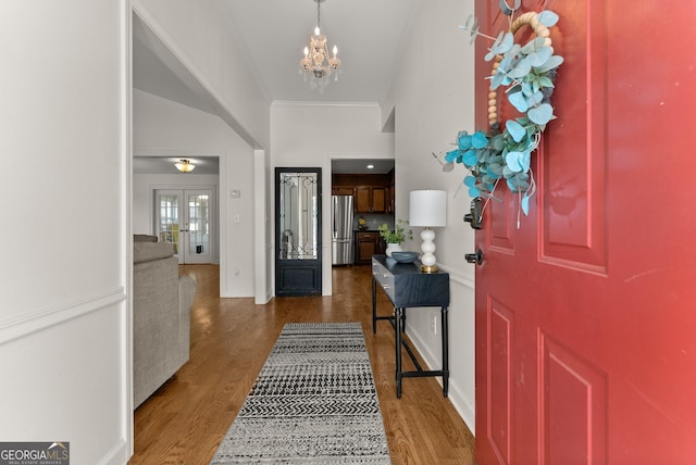 2605 Fort Apachee Trl, Dacula, GA 30019 - entrance foyer with a chandelier, stairs, wood finished floors, crown molding, and baseboards