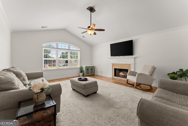 2605 Fort Apachee Trl, Dacula, GA 30019 - living room with a ceiling fan, a warm lit fireplace, vaulted ceiling, wood finished floors, and crown molding