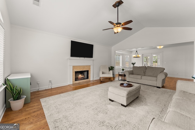 2605 Fort Apachee Trl, Dacula, GA 30019 - living room with vaulted ceiling, a fireplace, ceiling fan, wood finished floors, and baseboards