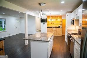 241 Sarann Ct NW, Lilburn, GA 30047 - kitchen with dark wood-style floors, white cabinetry, range, a center island, and recessed lighting