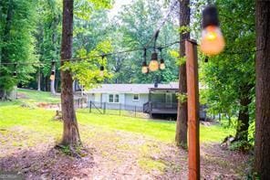 241 Sarann Ct NW, Lilburn, GA 30047 - view of grassy yard with a deck