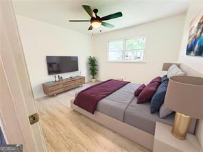 241 Sarann Ct NW, Lilburn, GA 30047 - bedroom featuring wood finished floors and a ceiling fan
