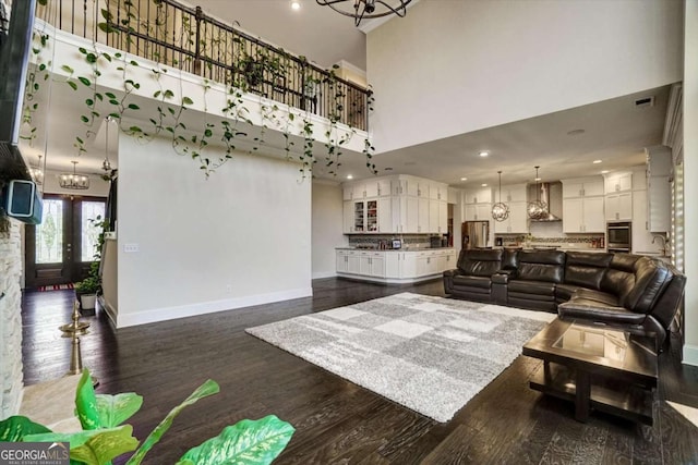 1835 Henley Way, Alpharetta, GA 30009 - living room featuring a chandelier, a high ceiling, baseboards, dark wood-type flooring, and recessed lighting