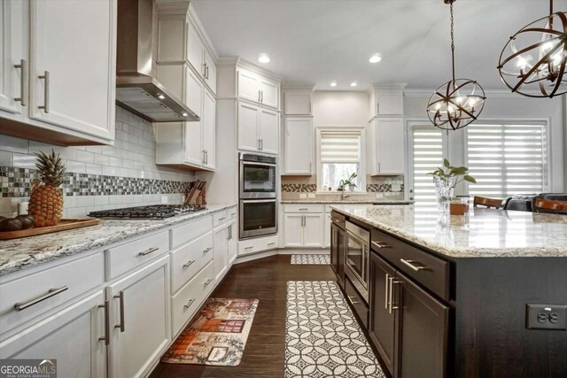 1835 Henley Way, Alpharetta, GA 30009 - kitchen with wall chimney exhaust hood, stainless steel appliances, white cabinets, a chandelier, and decorative backsplash
