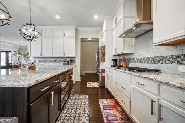 1835 Henley Way, Alpharetta, GA 30009 - kitchen featuring wall chimney exhaust hood, stainless steel appliances, ornamental molding, white cabinetry, and a chandelier