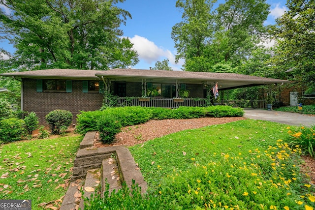 1138 Berkeley Rd, Avondale Estates, GA 30002 - view of front of house featuring concrete driveway, a front lawn, brick siding, an attached carport, and a porch