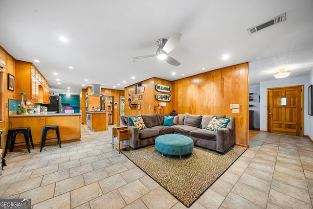 1138 Berkeley Rd, Avondale Estates, GA 30002 - living room with recessed lighting, stone tile flooring, wood walls, and a ceiling fan