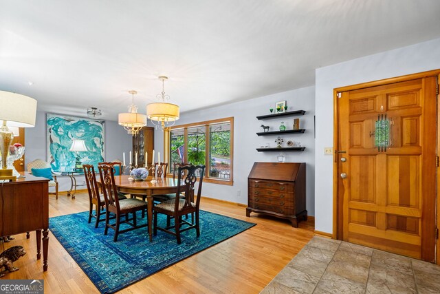 1138 Berkeley Rd, Avondale Estates, GA 30002 - dining area featuring a chandelier, wood finished floors, and baseboards