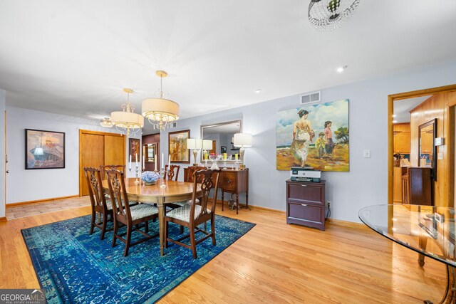 1138 Berkeley Rd, Avondale Estates, GA 30002 - dining area featuring a chandelier, wood finished floors, and baseboards