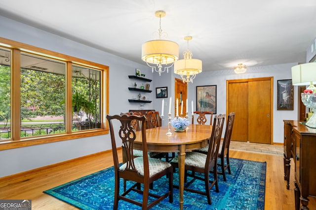 1138 Berkeley Rd, Avondale Estates, GA 30002 - dining area with wood finished floors, a chandelier, and baseboards