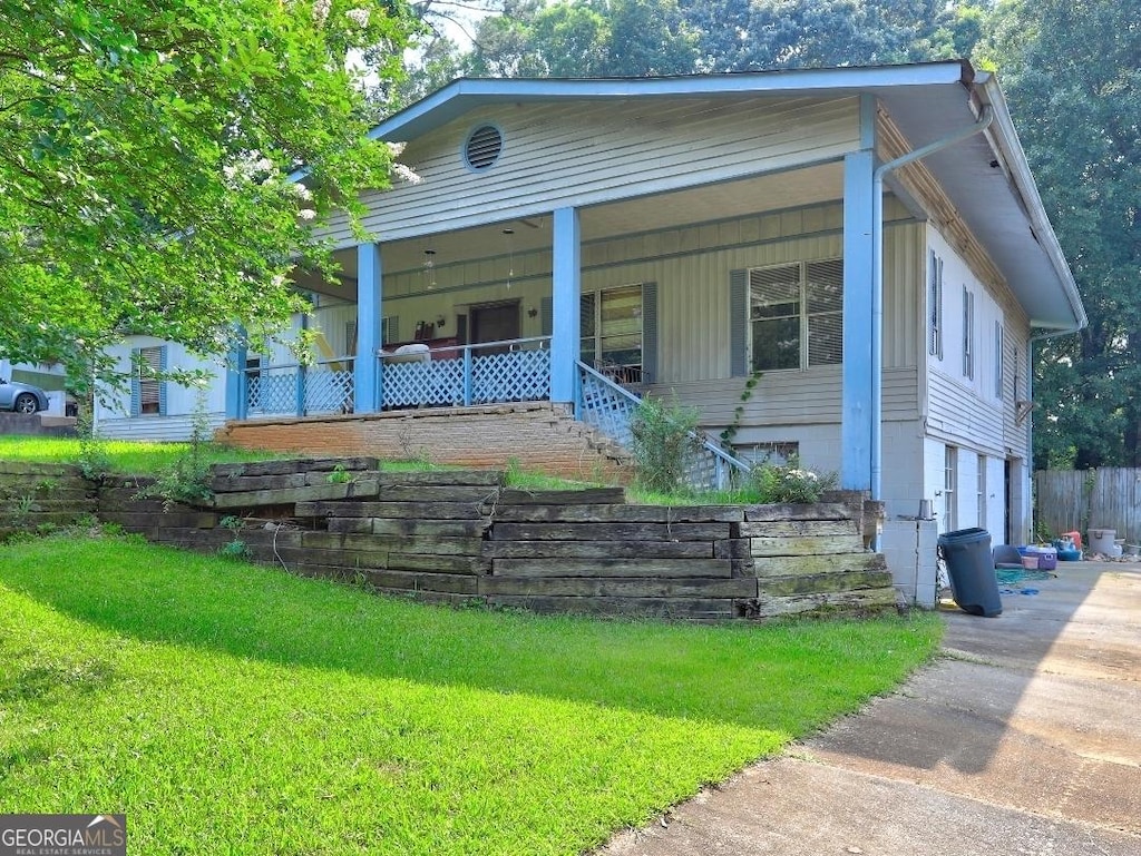 85 Knottingham Ct, Stockbridge, GA 30281 - view of front of property with covered porch, a front yard, stairs, and driveway