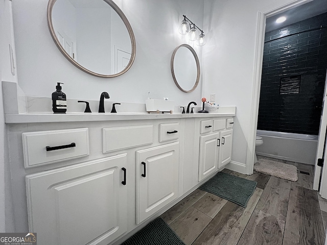 128 Golden Hills Dr, Woodstock, GA 30189 - full bath with double vanity, wood finished floors, shower / tub combination, toilet, and baseboards