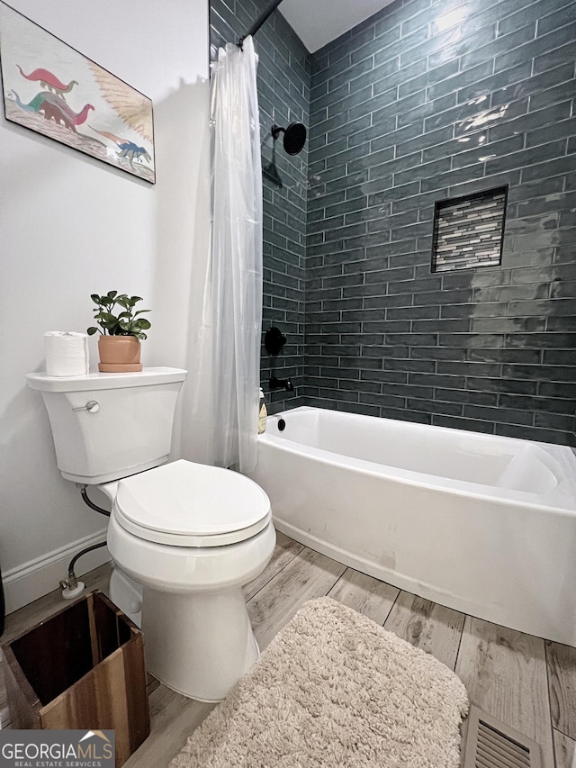 128 Golden Hills Dr, Woodstock, GA 30189 - bathroom with wood finished floors, toilet, and shower / bath combo with shower curtain