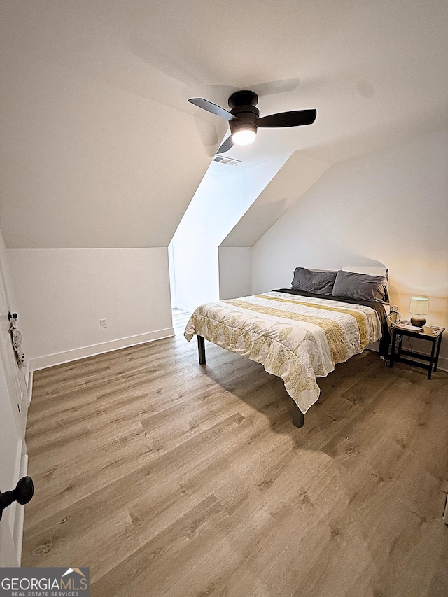 128 Golden Hills Dr, Woodstock, GA 30189 - bedroom with wood finished floors, vaulted ceiling, baseboards, and a ceiling fan