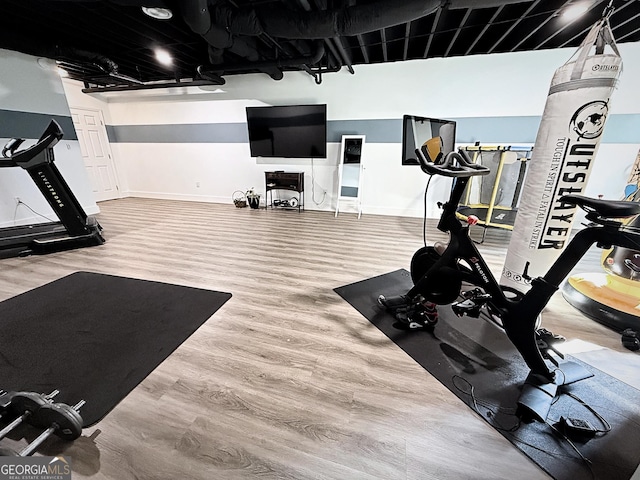 128 Golden Hills Dr, Woodstock, GA 30189 - workout room with wood finished floors and baseboards