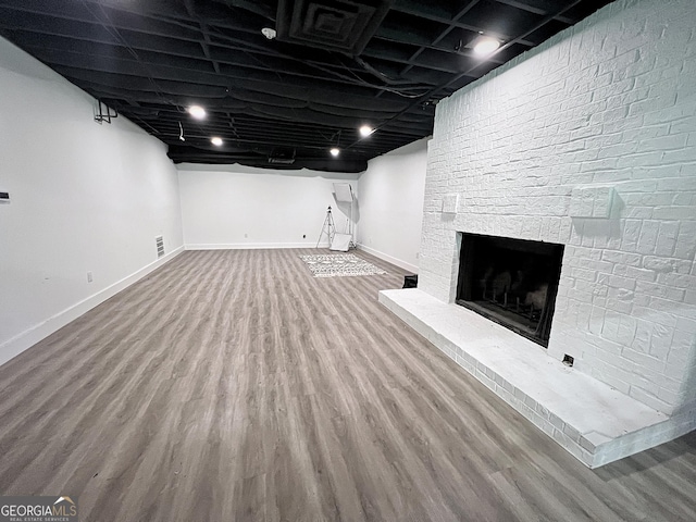 128 Golden Hills Dr, Woodstock, GA 30189 - finished basement with baseboards, wood finished floors, and a fireplace
