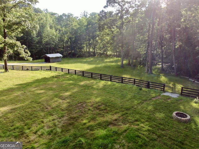 128 Golden Hills Dr, Woodstock, GA 30189 - view of yard featuring an outdoor structure, a view of countryside, and an outdoor fire pit