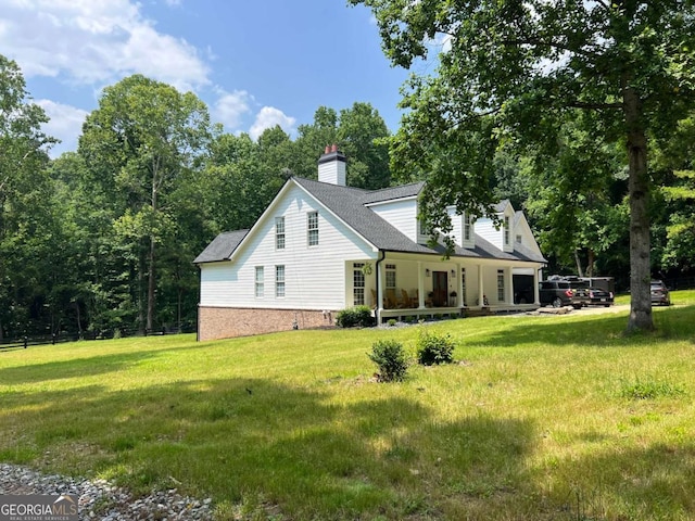 128 Golden Hills Dr, Woodstock, GA 30189 - view of home's exterior featuring a chimney, a yard, covered porch, and roof with shingles