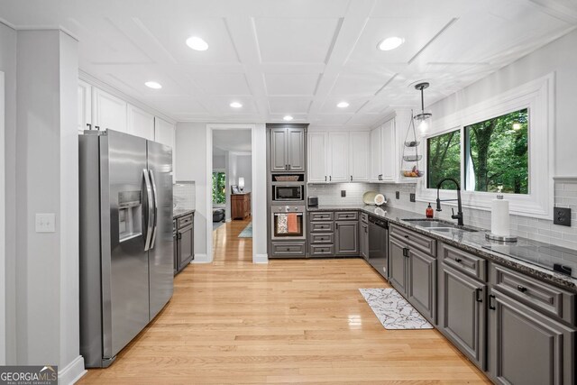 545 Matterhorn Way, Alpharetta, GA 30022 - kitchen with stainless steel appliances, a sink, light wood-style floors, backsplash, and white cabinets